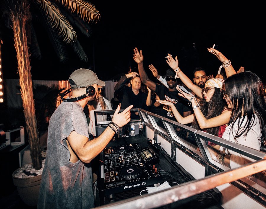 L.B.ONE sharing a moment with the crowd behind the DJ booth