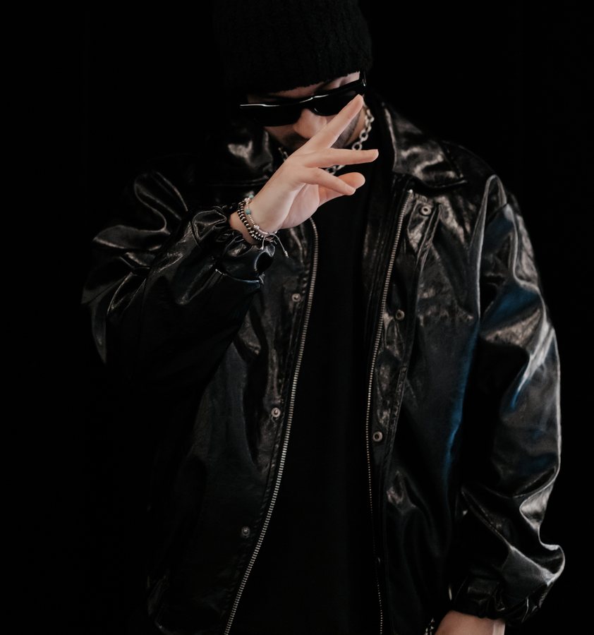 L.B.ONE in a black leather jacket, beanie and sunglasses